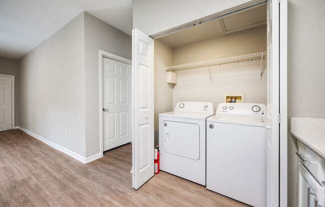 our spacious laundry room is equipped with a washer and dryer