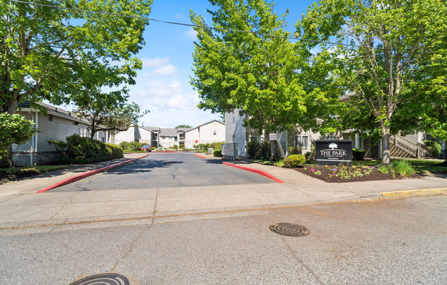 an empty street with houses on both sides and trees