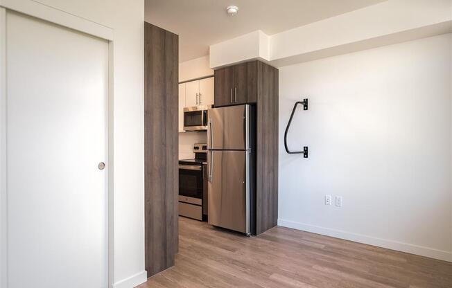 a kitchen with a stainless steel refrigerator in a room with a door