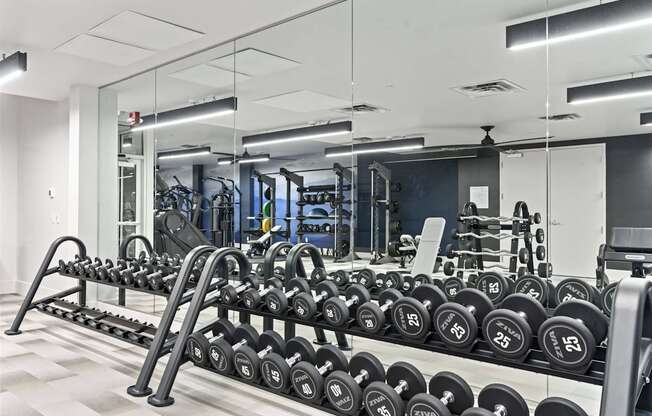 A gym with a row of dumbbells on a rack. at Brickside Heights, Millcreek, 84106