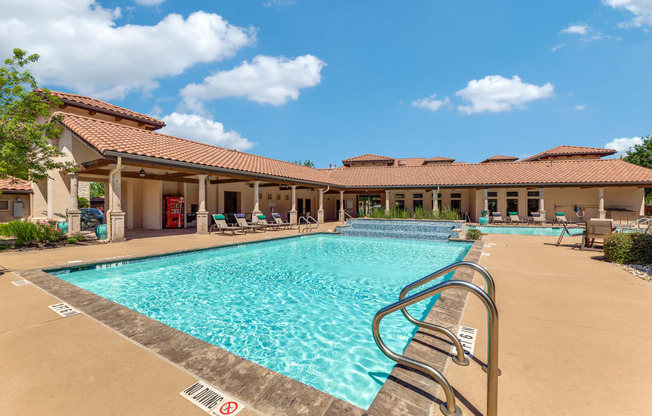 a swimming pool with a building in the background