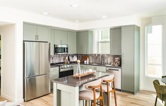 Kitchen and dining space with warm wood cabinetry, quartz surfaces, and expansive windows framing hillside views and natural light.