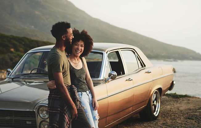 a man and woman standing in front of a car at North Grove, California  