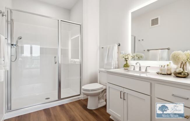 a white bathroom with a shower and a sink and a toilet