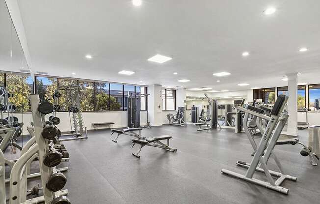 Community Fitness Center with Equipment at Madison Park Apartments located in Anaheim, CA.