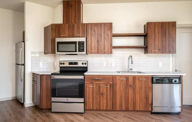 a kitchen with wooden cabinets and stainless steel appliances