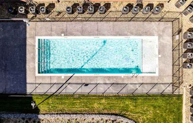 A rectangular pool with a diving board on the side.