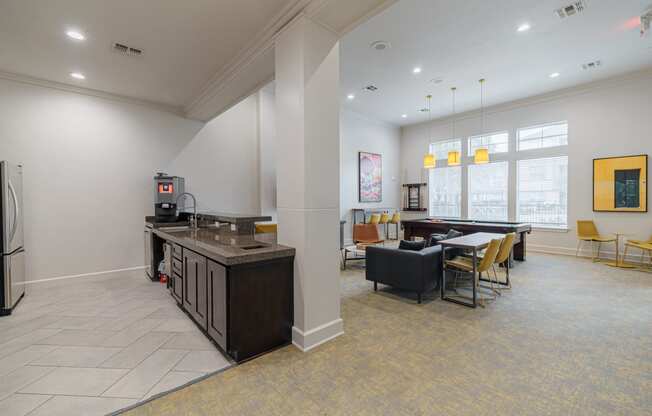 a clubhouse with a kitchen and a dining room with a table and chairs