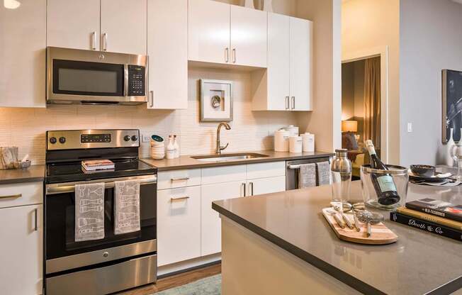 A modern kitchen with a stove top oven and microwave.