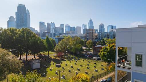 A cemetery with a city skyline in the background.