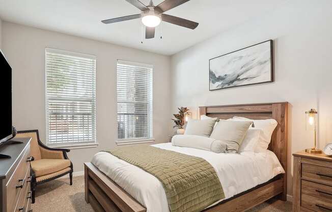 a bedroom with a large bed and a ceiling fan