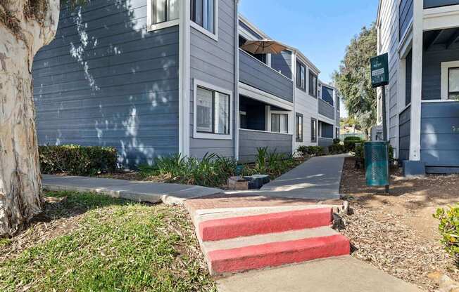 A row of houses with a red and white staircase in the foreground.