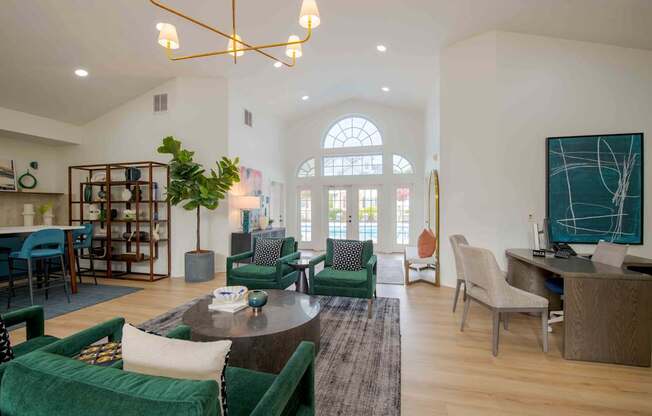 A living room with a green couch and a wooden floor.