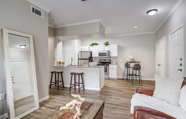 an open kitchen and living room with a couch and a table