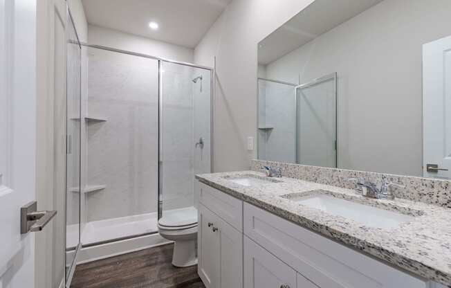 a bathroom with a sink and a shower and a toilet