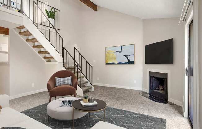 A living room with a fireplace and a painting on the wall.