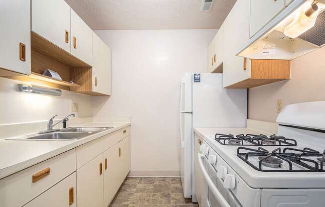 Kitchen with white appliances at Glen Oaks Apartments, Michigan, 49442