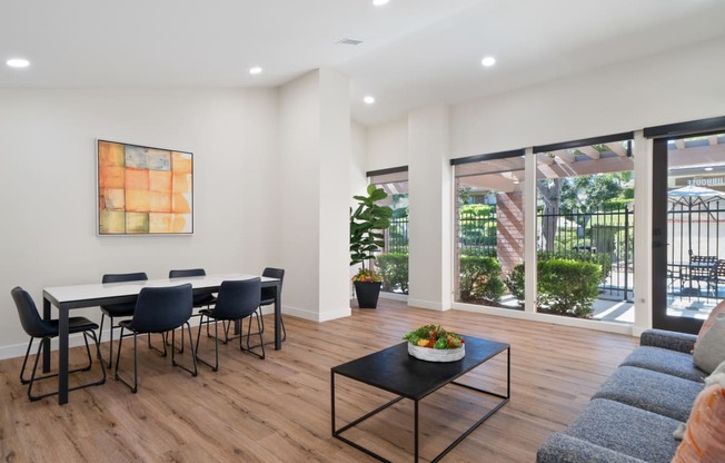 a dining room with a table and chairs and a large window