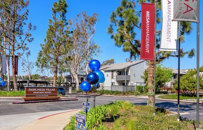 A Mesa Management sign is on a flagpole next to a sidewalk.