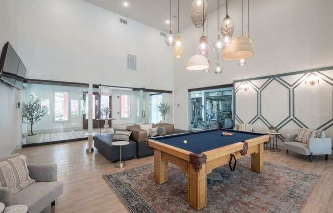 a living room with a pool table in the middle