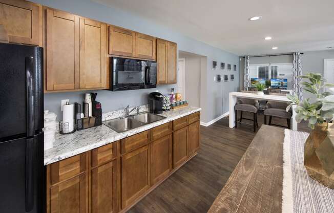 a kitchen with wooden cabinets and a sink and a refrigerator