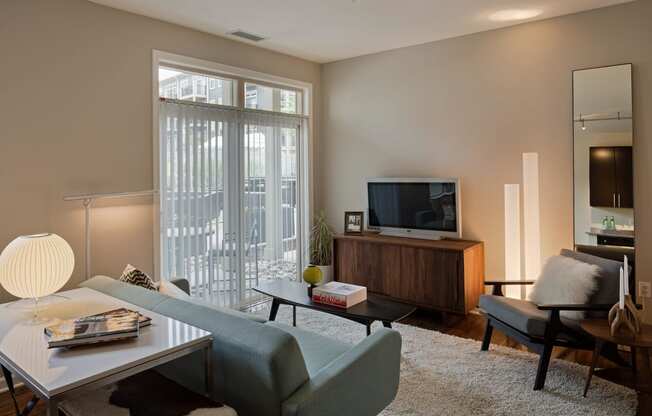 a living room with a couch and a table and a television