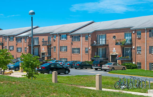 a large brick building with cars parked in a parking lot