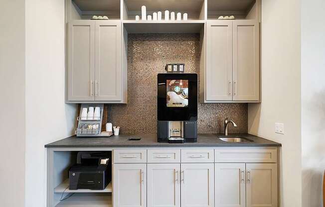 A kitchen with a microwave, oven, and sink.