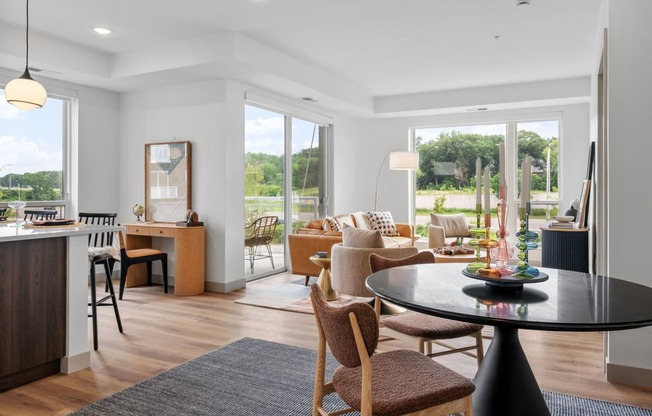 a living room and dining room with a table and chairs at The Mera, St Louis Park, Minnesota