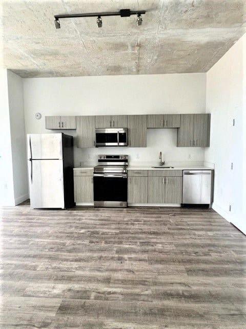 an empty kitchen with black and white appliances