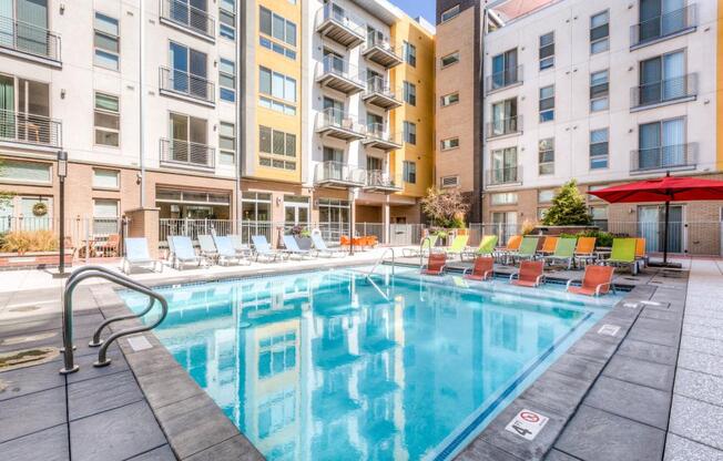 a swimming pool in front of an apartment building