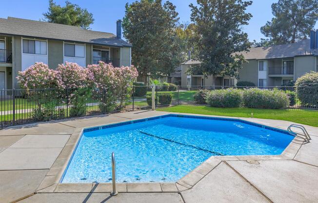 a house with a pool in front of a building