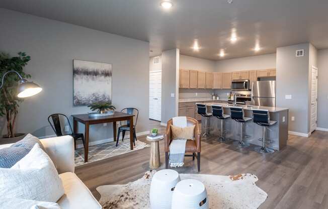 an open living room and kitchen with a dining room table and chairs