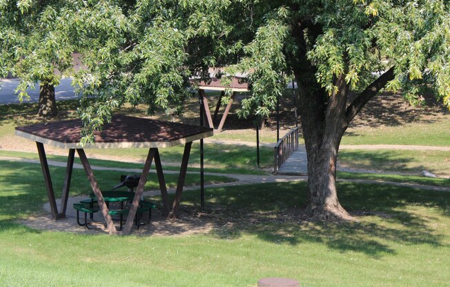 a picnic table under a tree in a park