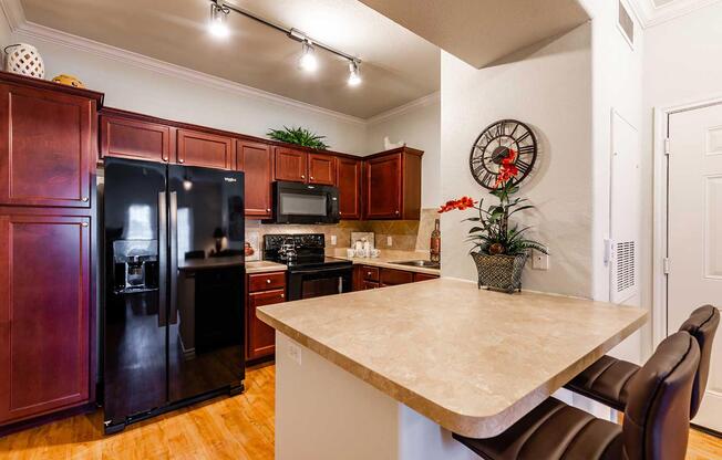 a modern kitchen with stainless steel appliances and wooden cabinets