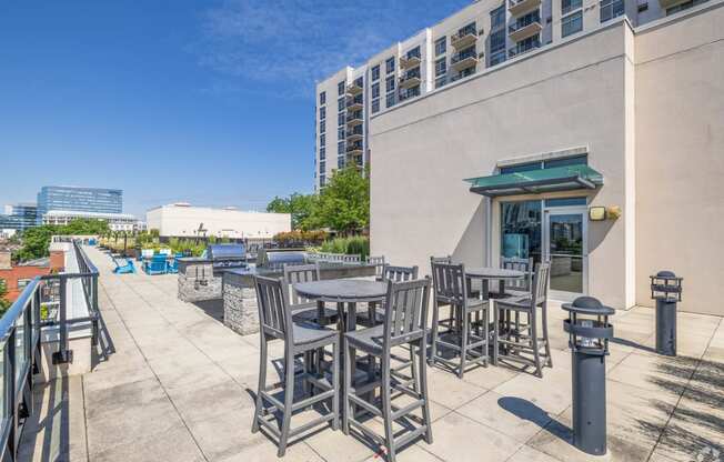 a patio with tables and chairs outside of a building