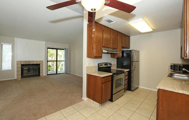 a large kitchen with stainless steel appliances and wooden cabinets