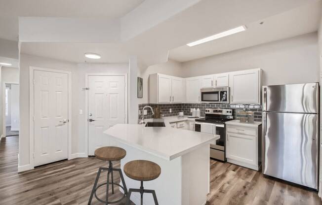 a kitchen with stainless steel appliances and a white counter top