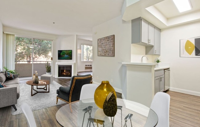 a living room with a glass table and chairs