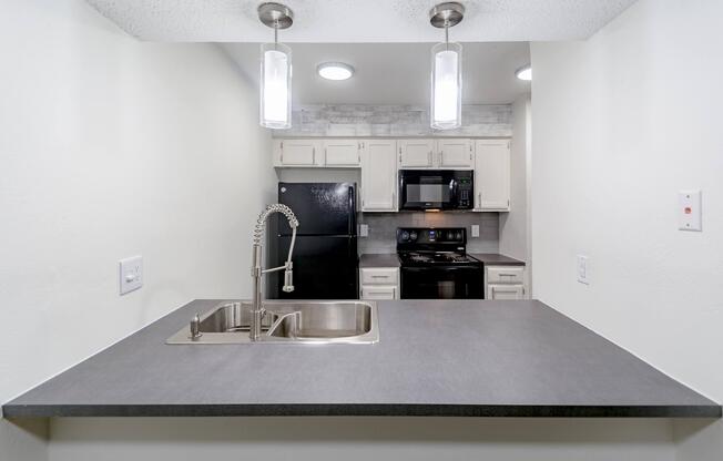 a stove top oven sitting inside of a kitchen