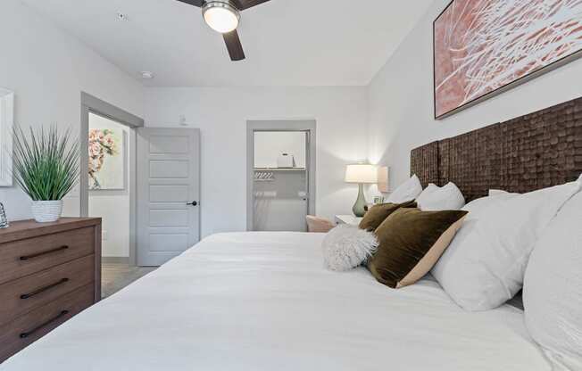 a bedroom with a large bed and a door to a bathroom