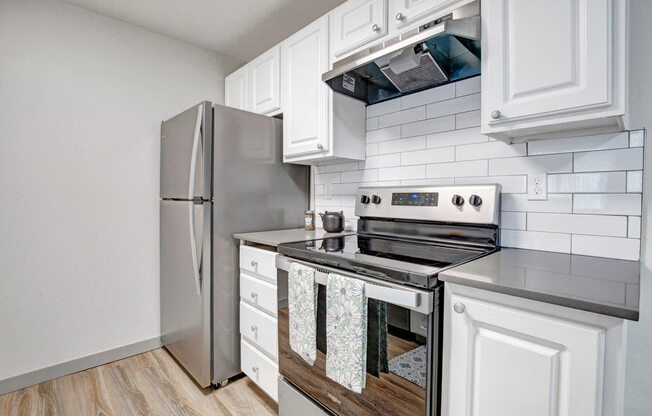 a kitchen with a stove top oven next to a refrigerator