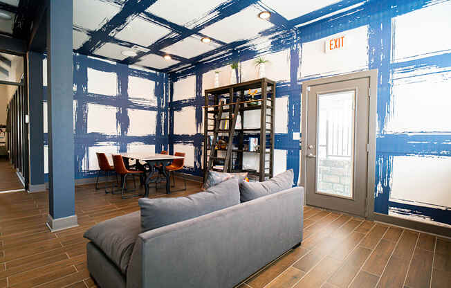 a living room with blue paint on the walls and a couch