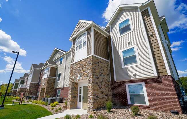 Modern apartment building with a clear blue sky at Copper Creek in Maize, KS 67101