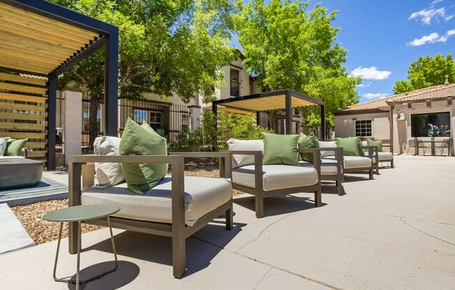 an outdoor patio with chairs and tables and a fire pit