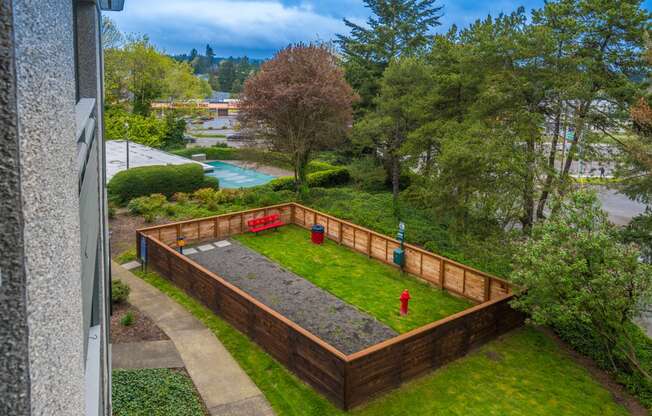 a backyard with a retaining wall and a fire hydrant