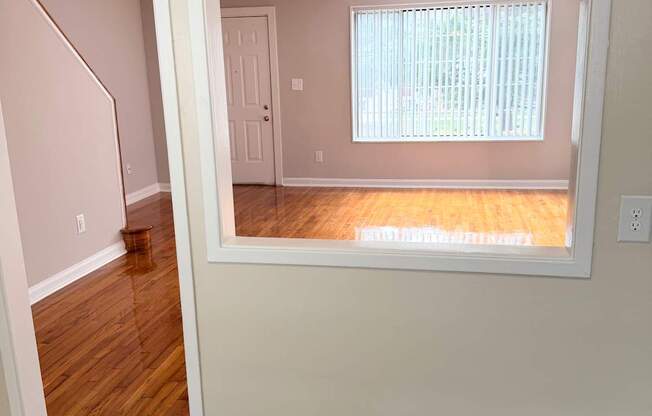 A room with a window and a ceiling fan.
