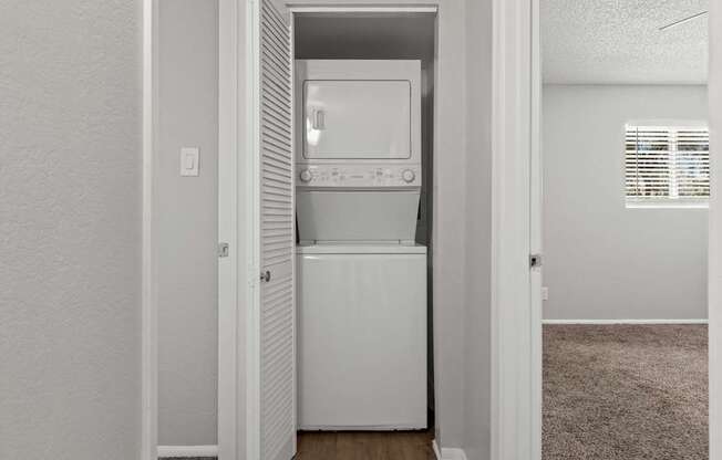 A white dishwasher is built into a kitchen cabinet.