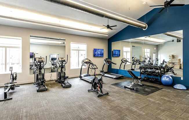 A spacious gym with a variety of exercise equipment.