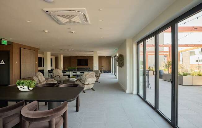 A modern dining room with a long table and chairs.